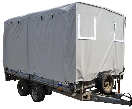 Large grey trailer cover with velcro flaps and hoops, secured to the trailer with bungee